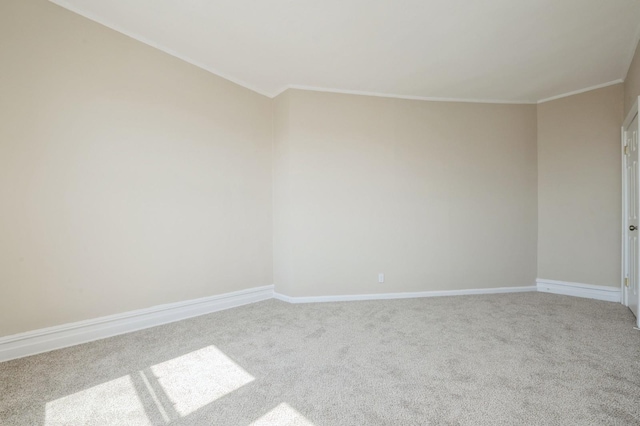unfurnished room with crown molding, baseboards, and carpet flooring