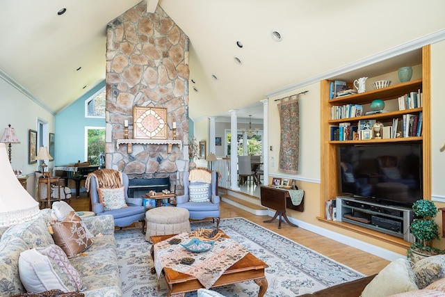 235 S Blvd, Nyack, NY 10960 - living area with decorative columns, plenty of natural light, wood finished floors, high vaulted ceiling, and a stone fireplace