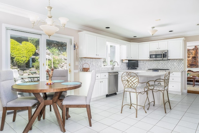 235 S Blvd, Nyack, NY 10960 - kitchen featuring stainless steel appliances, a chandelier, light countertops, a kitchen island, and a breakfast bar area