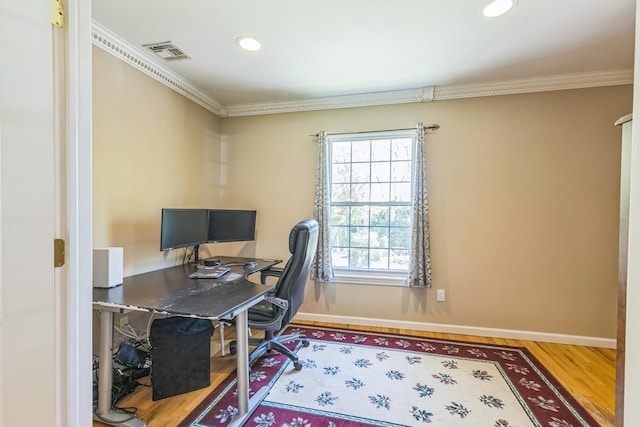 office space with baseboards, ornamental molding, and wood finished floors