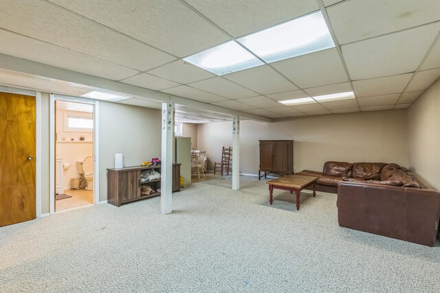 carpeted living area featuring baseboards