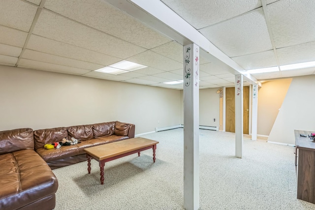 carpeted living area with baseboards, a paneled ceiling, and baseboard heating