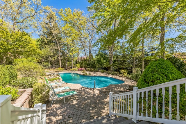 outdoor pool with a patio area