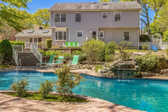 pool featuring a patio area and stairway