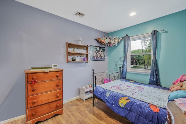 bedroom with light wood-type flooring, baseboards, and recessed lighting