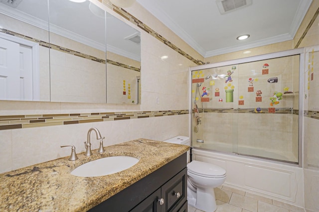bathroom featuring tile walls, bath / shower combo with glass door, crown molding, toilet, and tile patterned floors
