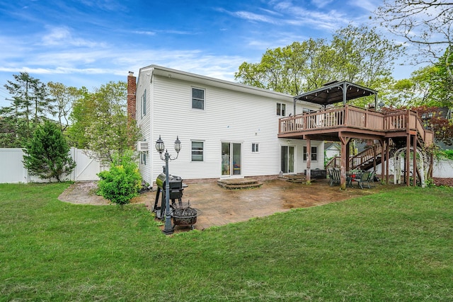 back of property featuring a wooden deck, a patio area, stairs, and a chimney