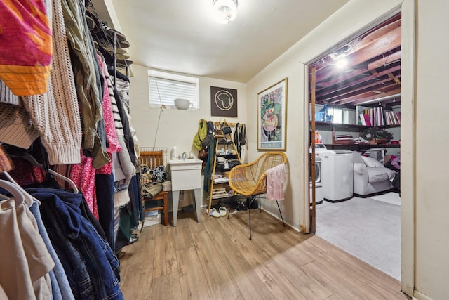 spacious closet featuring washer and clothes dryer and wood finished floors