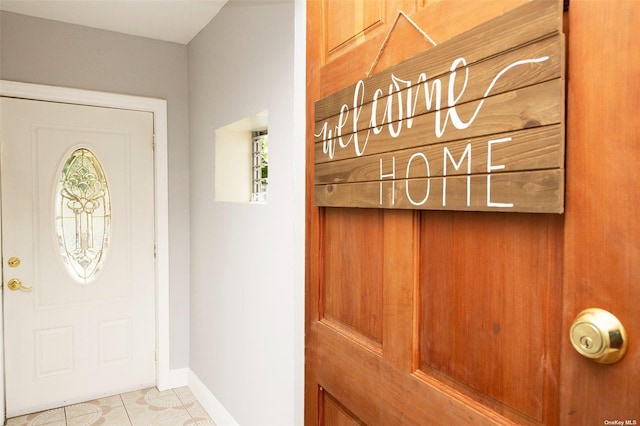 entryway featuring light tile patterned floors and baseboards