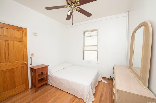 bedroom with ceiling fan and light wood-style flooring