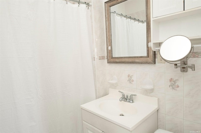 bathroom featuring tile walls and vanity