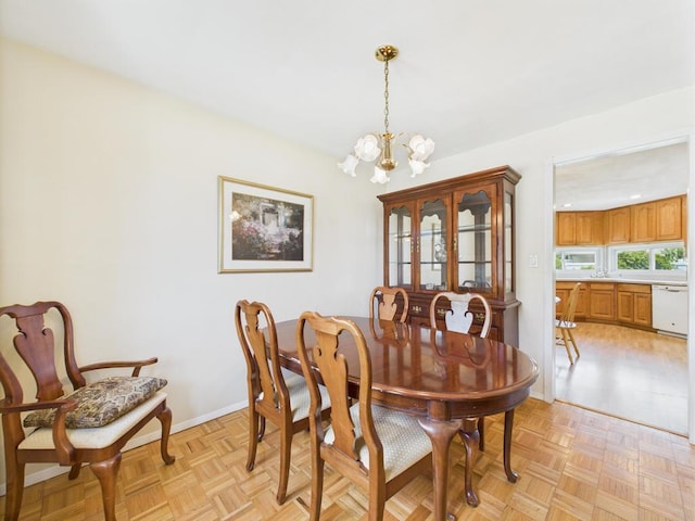 dining space with a chandelier and baseboards