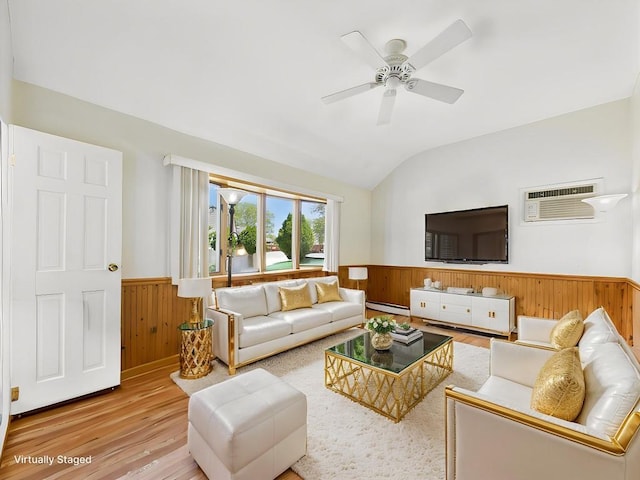 living room featuring wainscoting, wood finished floors, wooden walls, vaulted ceiling, and a baseboard radiator