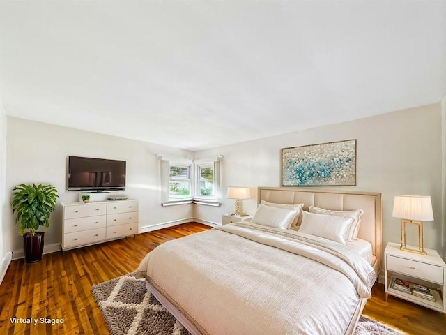 bedroom featuring baseboards and wood finished floors