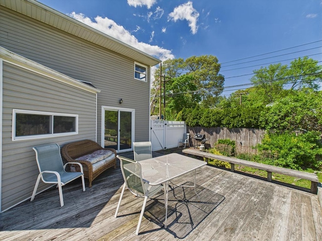 wooden deck featuring a fenced backyard and outdoor dining space
