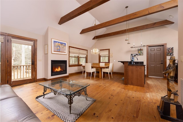 15 Chapin Trl, White Lake, NY 12720 - living room featuring a glass covered fireplace, high vaulted ceiling, light wood-style flooring, and a wealth of natural light