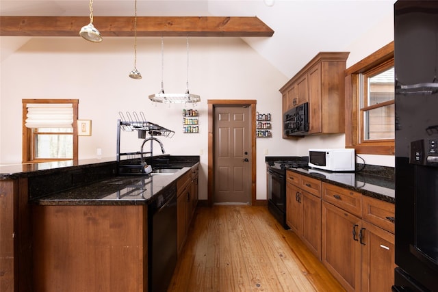 15 Chapin Trl, White Lake, NY 12720 - kitchen with brown cabinets, a sink, light wood-style floors, vaulted ceiling with beams, and black appliances