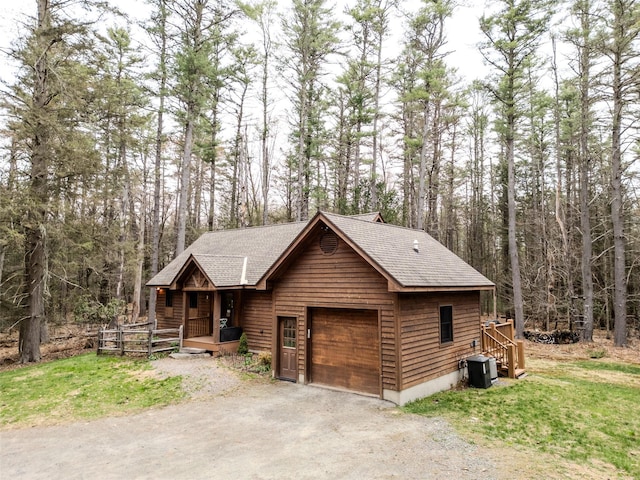 15 Chapin Trl, White Lake, NY 12720 - view of front of home featuring covered porch, a wooded view, central AC, and a shingled roof