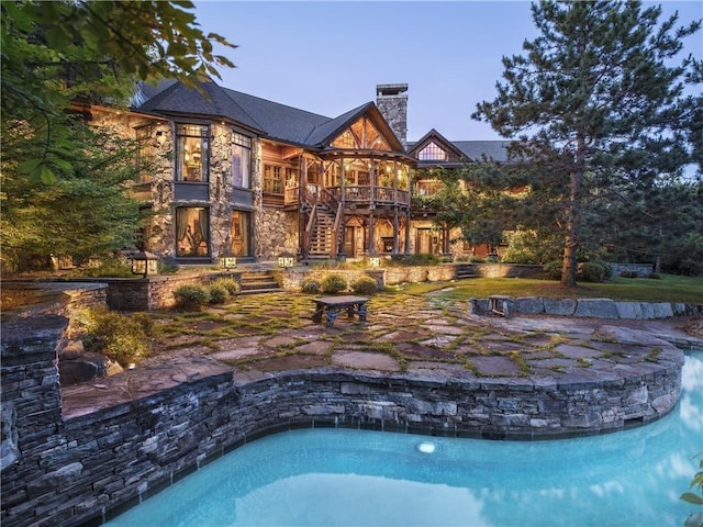 15 Chapin Trl, White Lake, NY 12720 - back of property with stairway, an outdoor pool, stone siding, and a chimney