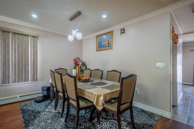dining area featuring baseboards, a baseboard radiator, crown molding, and wood finished floors
