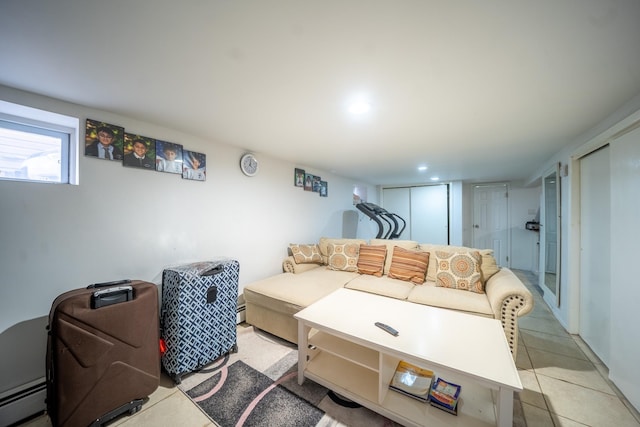 living room featuring a baseboard heating unit, light tile patterned floors, and recessed lighting