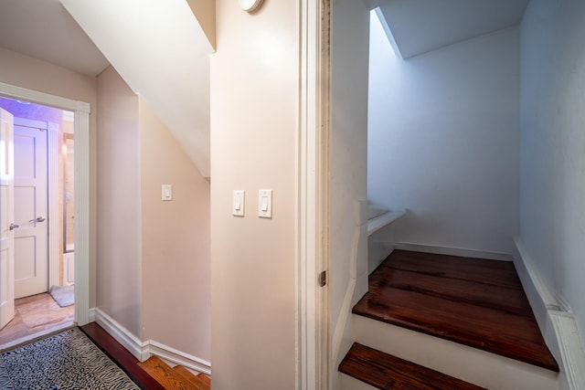 stairs featuring baseboards and wood finished floors