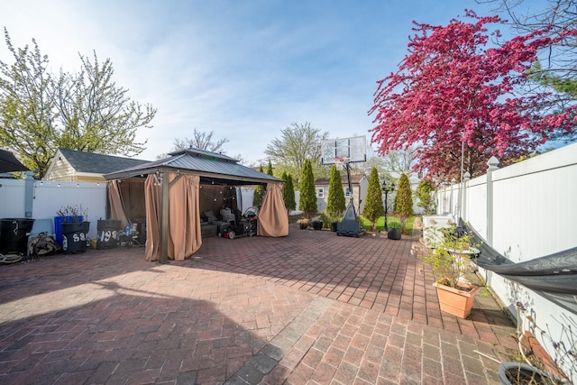 view of patio / terrace featuring a gazebo and a fenced backyard