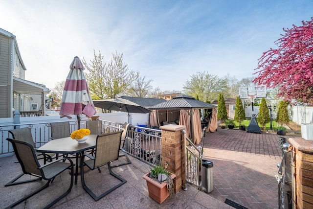 view of patio with a gazebo, a residential view, and outdoor dining area