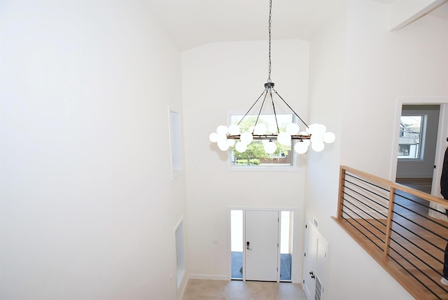 141 Flamingo St, Atlantic Beach, NY 11509 - entryway with high vaulted ceiling, a chandelier, and baseboards