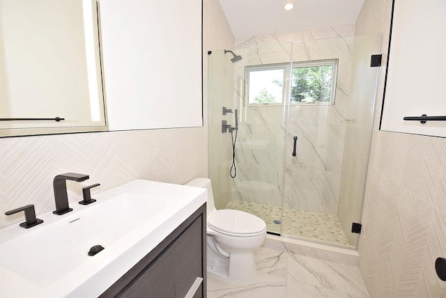 141 Flamingo St, Atlantic Beach, NY 11509 - bathroom with a marble finish shower, toilet, marble finish flooring, vanity, and tile walls