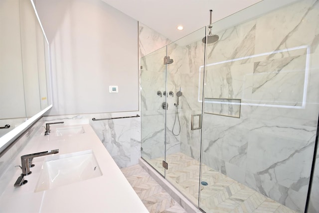 141 Flamingo St, Atlantic Beach, NY 11509 - bathroom featuring a marble finish shower, tile walls, recessed lighting, and double vanity