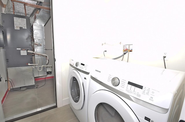 141 Flamingo St, Atlantic Beach, NY 11509 - washroom with washer and dryer, light tile patterned floors, and heating unit