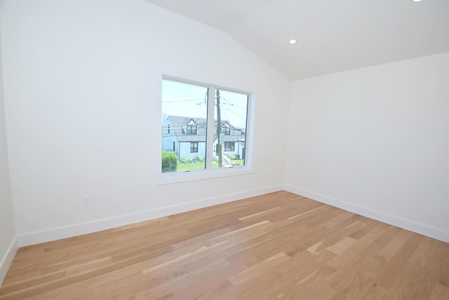 141 Flamingo St, Atlantic Beach, NY 11509 - unfurnished room with light wood-style flooring, lofted ceiling, and baseboards