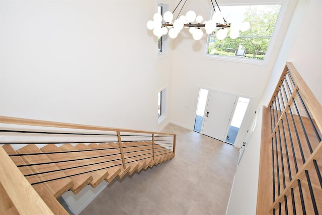 141 Flamingo St, Atlantic Beach, NY 11509 - entryway with a chandelier, stairway, a towering ceiling, and baseboards