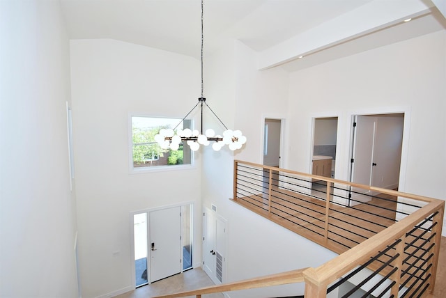 141 Flamingo St, Atlantic Beach, NY 11509 - stairs featuring high vaulted ceiling and a chandelier