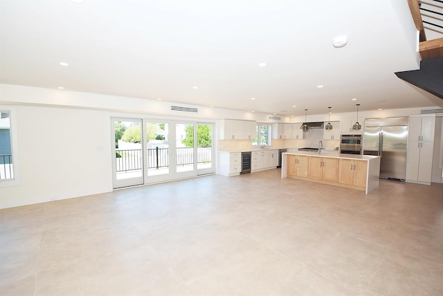 141 Flamingo St, Atlantic Beach, NY 11509 - unfurnished living room with beverage cooler, recessed lighting, and a sink