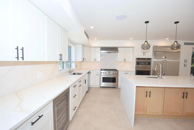 141 Flamingo St, Atlantic Beach, NY 11509 - kitchen featuring high quality appliances, a sink, wine cooler, light stone counters, and recessed lighting
