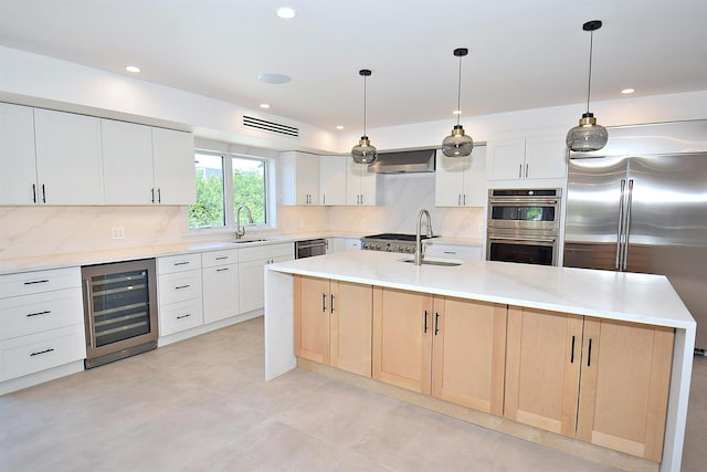 141 Flamingo St, Atlantic Beach, NY 11509 - kitchen with wine cooler, appliances with stainless steel finishes, a sink, a center island with sink, and recessed lighting