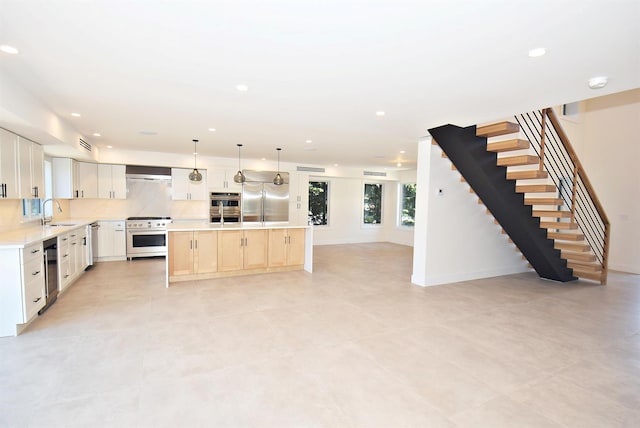 141 Flamingo St, Atlantic Beach, NY 11509 - kitchen with premium appliances, a sink, light countertops, open floor plan, and a kitchen island with sink