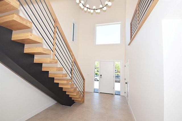 141 Flamingo St, Atlantic Beach, NY 11509 - foyer entrance with stairway, baseboards, a towering ceiling, and a chandelier