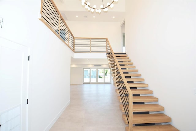 141 Flamingo St, Atlantic Beach, NY 11509 - stairway with a high ceiling, a chandelier, baseboards, and recessed lighting