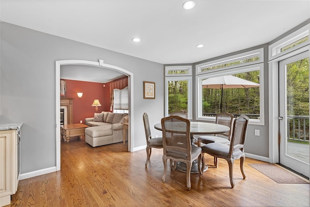 26 Garrity Blvd, Brewster, NY 10509 - dining room featuring a wealth of natural light, light wood-style flooring, baseboards, and arched walkways