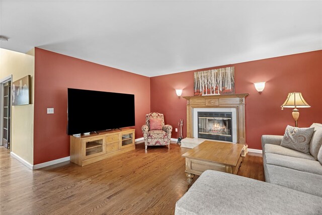 26 Garrity Blvd, Brewster, NY 10509 - living area with baseboards, a glass covered fireplace, and wood finished floors