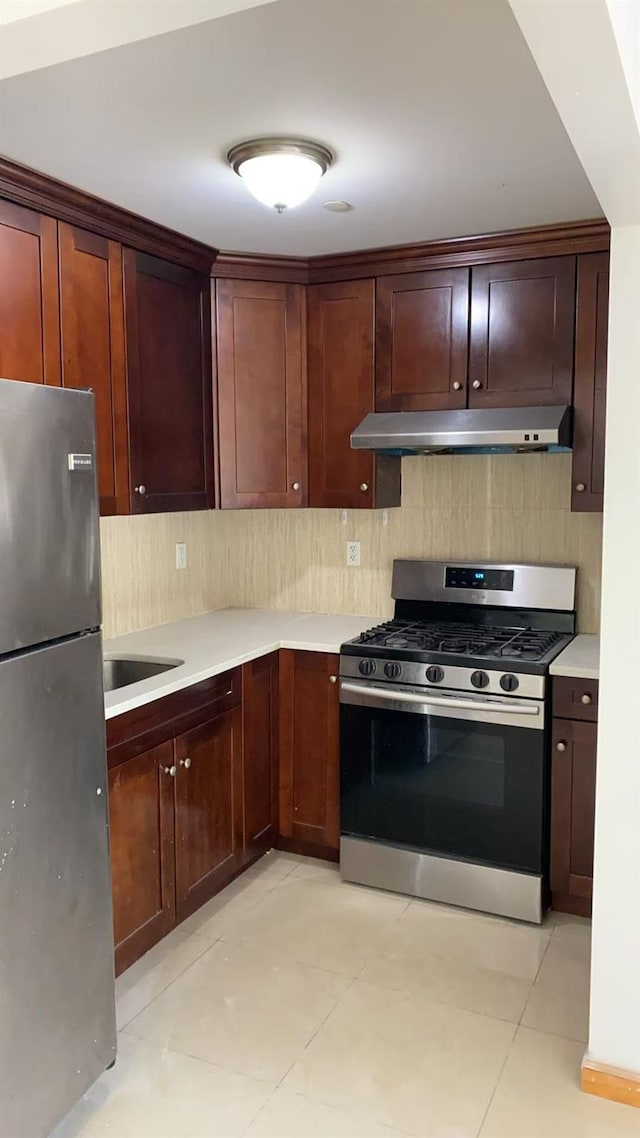35-19 Leavitt Unit 5H, Flushing, NY 11354 - kitchen with appliances with stainless steel finishes, under cabinet range hood, decorative backsplash, and light countertops