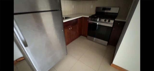 35-19 Leavitt Unit 5H, Flushing, NY 11354 - kitchen featuring appliances with stainless steel finishes, light countertops, and light tile patterned floors