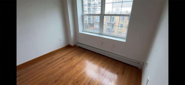 35-19 Leavitt Unit 5H, Flushing, NY 11354 - spare room with a baseboard radiator and light wood-style floors