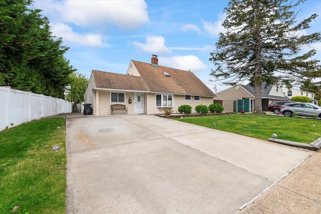view of front of home with concrete driveway and a chimney