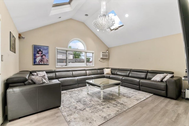 living room with a skylight, lofted ceiling, light wood-type flooring, and a wall mounted AC