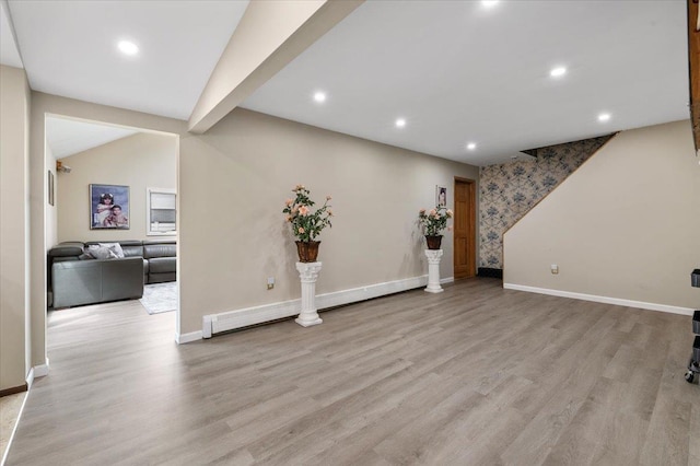 below grade area featuring light wood finished floors, baseboards, and recessed lighting