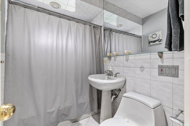 full bath with toilet, tile walls, and shower / bath combination with curtain
